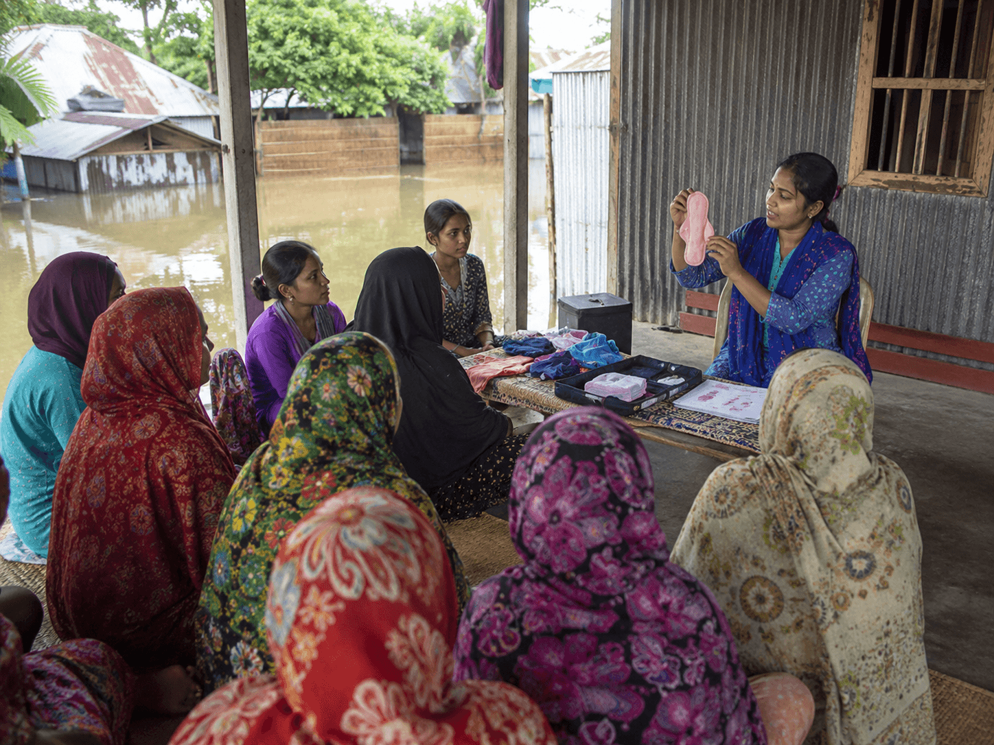 A community health worker distributing menstrual supplies